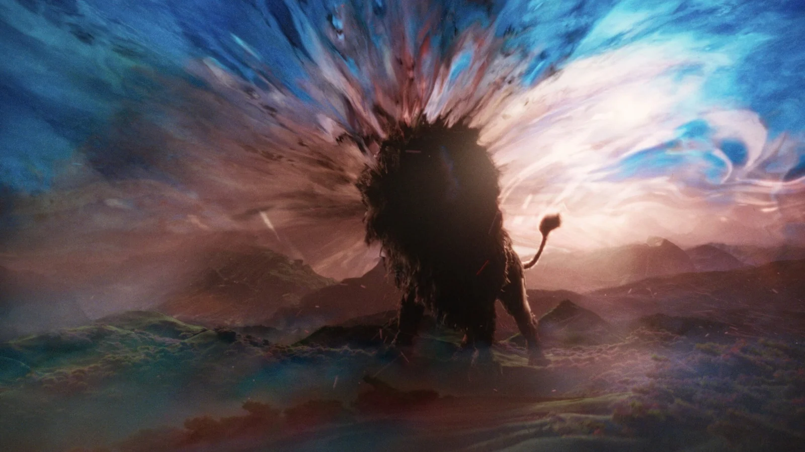 Leão em silhueta diante de uma explosão de cores no céu, em cena do trailer de Narnia